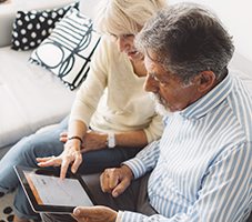 Couple reviewing information on tablet computer